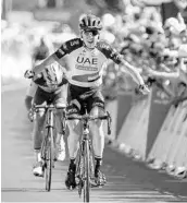  ?? JEFF PACHOUD/AFP/GETTY IMAGES ?? Ireland's Daniel Martin celebrates as he crosses the finish line Thursday to win the sixth stage of the Tour de France.