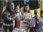  ?? ORIOL DURAN / AP ?? Injured people are treated in Barcelona after a white van jumped the sidewalk in the historic Las Ramblas district, crashing into a summer crowd of residents and tourists.