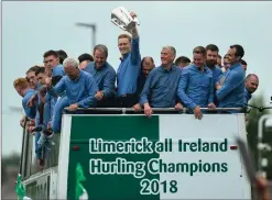  ?? Photo by Diarmuid Greene ?? William O’Donoghue raises the Liam McCarthy Cup alongside manager John Kiely and members of the team during the Limerick AllIreland Hurling winning team homecoming as the bus makes it’s way to the Gaelic Grounds in Limerick.