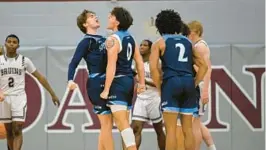  ?? TERRANCE WILLIAMS/FOR BALTIMORE SUN MEDIA ?? South River’s Cash Herndon, left, chest bumps Blake Burrows after a basket by Burrows during the second half of a game against Broadneck on Dec. 16. The Seahawks seniors made a promise to their coach as freshmen that they can end the program’s postseason title drought.