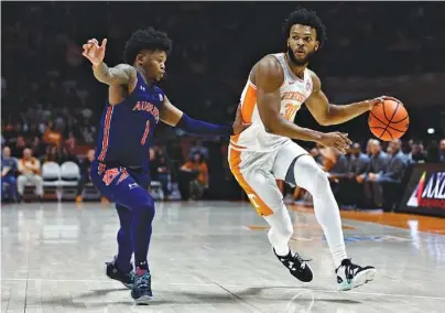  ?? AP PHOTO/WADE PAYNE ?? Tennessee senior guard Josiah-Jordan James drives past Auburn’s Wendell Green Jr. during the first half of Saturday afternoon’s 46-43 win for the Vols inside Thompson-Boling Arena. James scored 15 points and grabbed 14 rebounds.