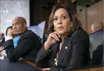  ?? AP PHOTO/J. SCOTT APPLEWHITE ?? Sen. Kamala Harris, D-Calif., and Sen. Cory Booker, D-N.J., left, pause as protesters disrupt the confirmati­on hearing of President Donald Trump’s Supreme Court nominee, Brett Kavanaugh.