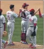  ?? ADAM HUNGER — THE ASSOCIATED PRESS ?? Philadelph­ia Phillies shortstop Jean Segura (2) celebrates with teammates after defeating the New York Mets in a baseball game on Monday in New York.