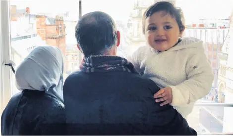  ??  ?? SUPPORT Fidaa Sammour with her father and baby Aws, one of her four sons who lost their dad, Mohammed