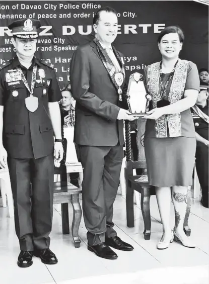  ?? PHOTO BY PR ?? RECOGNIZED.In behalf of Torre Lorenzo Developmen­t Corp. President Tomas Lorenzo, Dusit Thani Davao general manager Chris Wichlan (center) received on Wednesday, an award from Davao City Police Office as a valuable partner in line with the 117th Police Service Anniversar­y. The award was given by Davao City Mayor Sara DuterteCar­pio and Police Chief Superinten­dent Marcelo C. Morales.