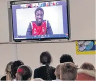  ??  ?? Nottingham Forest player Tyler Blackett discusses children’s questions at Porchester Junior School as they joined forces to “Show Racism the Red Card”. Pupils work regularly with Aaron Cuttriss of Nottingham Forest Community Trust (NFCT) in their “Primary Stars” programme, keeping fit and gaining sports skills. So when they heard from Aaron that they were going to take part in a virtual meeting with some of football’s most gifted profession­als, they took their preparatio­n for discussion­s very seriously. During the Q&A, children were able to ask searching questions of Tyler Blackett, Jason Lee, David Kelly, Chris Iluwemo and Yassine En-neyah, and the topics covered were about equality and the campaign Show Racism the Red Card. Head teacher Julie Fidler said: “The children were absolutely delighted to take part in such an amazing event.” Pupil Ronnie Osborne, 11, said: “I asked if they think women should get equal pay in football because for me I think it is important that they do.”