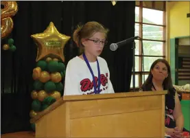  ?? Joseph B. Nadeau/The Call ?? Fifth grader Madelyn McNeil reads her D.A.R.E. essay as Halliwell Principal Jennifer D. Daigneault looks on.