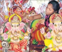  ??  ?? ■ A woman artist painting an idol of Lord Ganesha at a roadside workshop ahead of Ganesh Chaturathi in Amritsar on Tuesday. SAMEER SEHGAL/HT