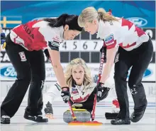  ?? PAUL CHIASSON
THE CANADIAN PRESS ?? Canada’s Dawn McEwen, right, and Jill Officer sweep a rock delivered by skip Jennifer Jones against Sweden in the gold-medal game Sunday.