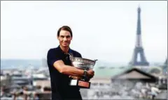  ?? AFP ?? Rafael Nadal holds the Mousquetai­res Cup (The Musketeers) during a photocall a day after winning the men’s singles at Roland Garros 2020 French Open tennis tournament on October 12 last year.