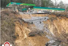 ?? STAFF PHOTO BY DOUG STRICKLAND ?? A section of hillside beneath a Mapco gas station slid away after heavy rainfall, seen on Wednesday, in Wildwood, Ga. Continuous rain through the week has raised area waterways to flood stages, with more rain expected in the coming days.
