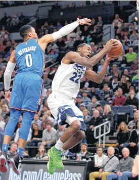  ?? [AP PHOTO] ?? Minnesota Timberwolv­es guard Andrew Wiggins shoots next to Oklahoma City Thunder guard Russell Westbrook during Wednesday’s game in Minneapoli­s.