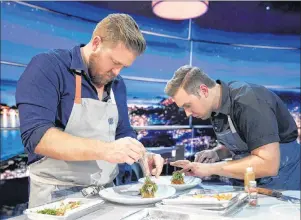  ?? THE CANADIAN PRESS/HO, NETFLIX, GREG GAYNE ?? Chefs Timothy Hollingswo­rth, left, and Darren MacLean are shown in a scene from Netflix’s “The Final Table” in this undated handout photo. Calgary chef Darren MacLean says it’s time the world recognizes his city as the next foodie hotspot. And so the outspoken culinary whiz shines a light on his Alberta city this week as the sole Canadian contender on Netflix’s new competitiv­e cooking series “The Final Table.”