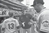  ?? ALEX BRANDON/AP ?? Mets manager Buck Showalter smiles as he reaches to shake hands with relief pitcher Edwin Diaz, right, after a win over the Nationals on Thursday at Nationals Park in Washington.