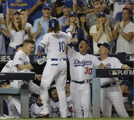  ?? DAVID J. PHILLIP/THE ASSOCIATED PRESS ?? The Dodgers’ Justin Turner hit his fourth home run of the post-season, a two-run shot in the sixth inning, to put his team ahead to stay on Tuesday.