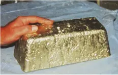  ?? STEVE VOYNICK ?? This newly poured, 72-pound ingot of gold-silver contains 734 troy ounces of gold; large open-pit mines will pour an ingot every day.