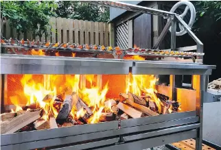  ??  ?? The wood-fired Argentine grill is the darling of celebrity chefs. Top-end stainless steel grills include those made by Grillworks of Michigan, above. Offset cookers, like the Yoder brand, make it easy to create real barbecue, with low, slow cooking and...