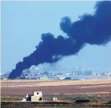  ?? LEFTERIS PITARAKIS/ASSOCIATED PRESS ?? Smoke billows from a fire inside Syria during a bombardmen­t by Turkish forces Wednesday. The attack began after U.S. forces pulled back from the area.