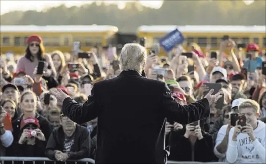  ?? Andrew Harnik The Associated Press ?? President Donald Trump speaks Saturday to an overflow crowd at a rally at Southern Illinois Airport in Murphysbor­o, Ill.