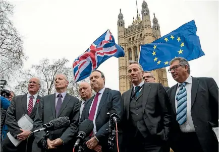  ?? PHOTO: GETTY IMAGES ?? Democratic Unionist Party (DUP) deputy leader Nigel Dodds speaks to the media as a protester waves flags outside the Houses of Parliament in London, after British Prime Minister Theresa May was forced to pull out of a Brexit deal with Brussels because...