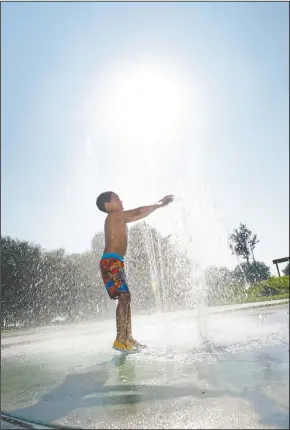  ?? NEWS-SENTINEL PHOTOGRAPH­S BY BEA AHBECK ?? Above and below right: Eric Valladares, 6, of Stockton, plays in the water feature at Micke Grove Park in Lodi on Thursday. Below left: Tanya Valladares watches as her son, Eric, plays in the water feature.