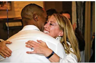  ??  ?? Mary Montgomery (right) hugs Gerald Parker after they both won seats on the Montgomery Court of Common Pleas, at Montgomery County Democratic Party’s watch party, Tuesday. Democrats did well in the county, but Republican Mike Foley beat Democrat Russ Joseph for Clerk of Courts.