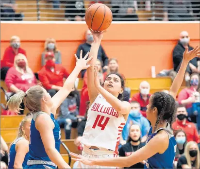  ?? PHOTOS BY KYLE TELECHAN / POST-TRIBUNE ?? Jessica Carrothers (14), who is averaging 27.3 points in the postseason, puts up a shot during Crown Point’s 62-46 win against Fort Wayne Carroll in the 2021 Class 4A LaPorte Semistate on Saturday.