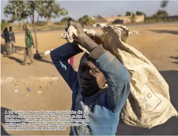  ??  ?? A boy carries a bag used to transport cobalt-laden dirt and rock at a mineral market outside Kolwezi, Congo, on June 7. A Washington Post investigat­ion found that child labour and unsafe working conditions are part of the cobalt mining process.—...