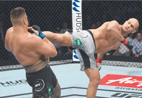  ?? Picture: GETTY IMAGES ?? TOUGH GOING: Junior Dos Santos of Brazil kicks Tai Tuivasa of Australia in their heavyweigh­t UFC bout in Adelaide.