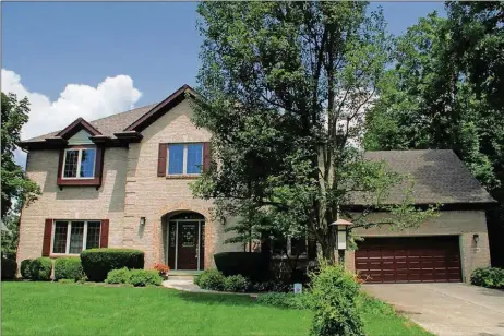  ?? CONTRIBUTE­D PHOTOS BY KATHY TYLER ?? The brick-and-cedar home has about 3,520 sq. ft. of living space plus the basement. Space above the garage has been finished into a bonus room, and the basement has been finished into a recreation room and exercise room and is plumbed for a bathroom.