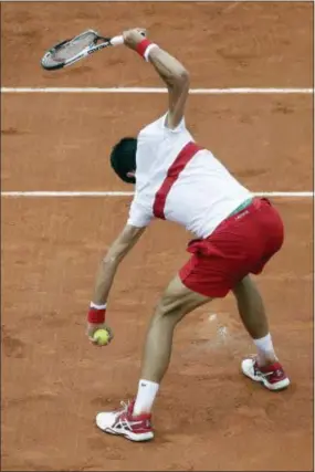  ?? ALESSANDRA TARANTINO — THE ASSOCIATED PRESS ?? Novak Djokovic breaks his racket during his third-round match French Open against Roberto Bautista Agut in Paris on Friday. won in four sets to advance. in the Djokovic