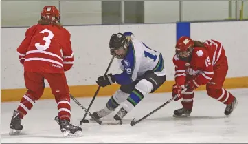  ?? STEVEN MAH/SOUTHWEST BOOSTER ?? Broncos’ forward Autumn Nimegeers (centre) tried to split a pair of Notre Dame players during a 3-2 loss last week.