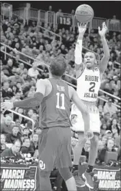  ?? Justin K. Aller Getty Images ?? RHODE ISLAND guard Fatts Russell goes up for a jump shot against Oklahoma star Trae Young.