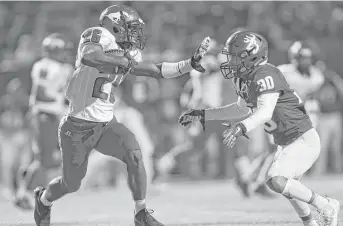  ??  ?? North Shore’s Michael Boult, left, intercepts a pass in Deer Park’s end zone during the third quarter. North Shore beat Deer Park 48-7 on Friday night in the 6A Division I bi-district playoffs.