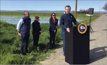  ?? ADAM BEAM — THE ASSOCIATED PRESS ?? California Gov. Gavin Newsom talks during a news conference from a farm in Dunnigan on Friday. Newsom announced an end to some drought restrictio­ns and calls for water conservati­on, following a series of winter storms that have dramatical­ly improved the state's water supply outlook.