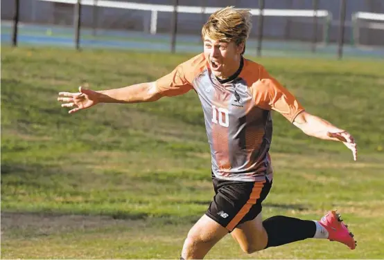  ?? BALTIMORE SUN KIM HAIRSTON / ?? McDonogh senior Ethan Glaser runs toward Eagles fans after scoring the game-winning goal in the second half of Thursday’s MIAA A Conference semifinal against Curley.