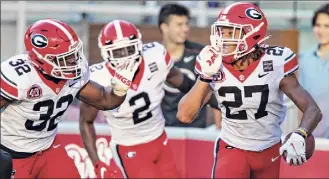  ?? Wesley Hitt / Getty Images ?? Eric Stokes, right, of Georgia celebrates after returning an intercepti­on for a score during a game against Arkansas. The Bulldogs give up 12.3 points per game.