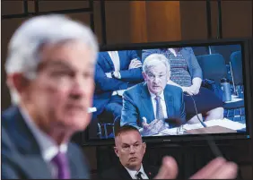  ?? HAIYUN JIANG / THE NEW YORK TIMES ?? A monitor displays Jerome Powell, the Federal Reserve chair, as he testifies in the foreground at a Senate committee hearing Tuesday on Capitol Hill. In light of recent strong data, Powell said the Federal Reserve was likely to raise rates higher — and perhaps faster — than expected to try to tame high inflation.