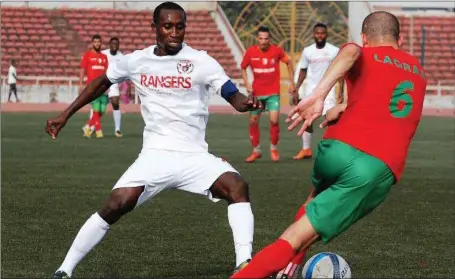  ??  ?? Godwin Aguda of Rangers (left) here challenged by a USMBA of Algeria player during the early stage of the CAF Confederat­ion Cup. With the win in Maseru, the Flying Antelopes are close to qualifying for the group stage of the competitio­n