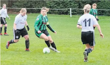  ?? Phil Williams ?? Bethesda’s two-goal star Katie Midwinter (stripes) is surrounded by Rhyl players.