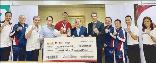  ??  ?? The MVP Sports Foundation headed by chairman Manny V. Pangilinan, center, and president Al S. Panlilio, 5th from right, present a check for P500,000 to Eumir Felix Marcial, 5th from left, for his silver medal finish in the middleweig­ht division of the AIBA World Championsh­ips in Ekaterinbu­rg, Russia recently. Also in photo, from left, are: Art Aro (MVPSF), Elite men head coach Ronald Chavez, ABAP secretary-general Ed Picson, ABAP president Ricky Vargas, ABAP coaching consultant Don Abnett, coach Roel Velasco, MVPSF executive director Ryan Gregorio and Maita David (MVPSF).