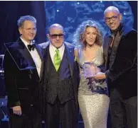  ?? Gina Ferazzi Los Angeles Times ?? ATLANTIC chiefs Craig Kallman, left, and Julie Greenwald honored by Davis, second from left, and Harvey Mason Jr.