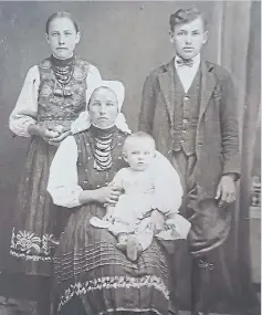  ?? COURTESY OF STEVE KOBELYK ?? Pauline Chorna (with baby), poses with her first husband and an unidentifi­ed woman in this undated photo. Chorna died in 1977, nine years after the grave was purchased.