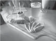  ?? Robert F. Bukaty/the Associated Press ?? Duck is served with a warm baguette and handcrafte­d condiments at Duckfat, a small sandwich shop in Portland, Maine.