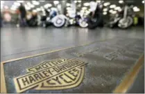  ?? KEITH SRAKOCIC — THE ASSOCIATED PRESS FILE ?? Rows of motorcycle­s are parked behind a bronze plate with corporate informatio­n on the showroom floor at a Harley-Davidson dealership in Glenshaw, Pa.
