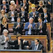  ?? AP/PAUL WHITE ?? Prime Minister Mariano Rajoy (bottom right) is applauded by party members after his speech Wednesday at the Spanish parliament in Madrid. Rajoy said he rejected offers of mediation in the Catalonia crisis, and called for respect of Spanish law, a day...