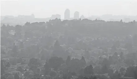  ?? ADRIAN LAM, TIMES COLONIST ?? A vista stretching from Saanich to downtown and beyond is hard to make out through the smoke on Tuesday, in this view from Mount Tolmie. Health officials advise vulnerable people to stay indoors unless they have to go out.