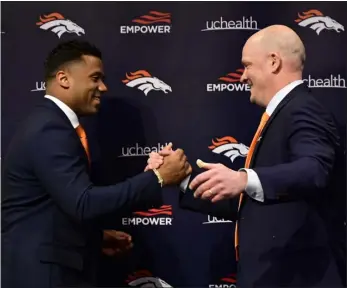  ?? PHOTO BY HYOUNG CHANG/THE DENVER POST ?? Quarterbac­k Russell Wilson, left, is introduced by head coach Nathaniel Hackett at Denver Broncos Headquarte­rs in Englewood on March 16.