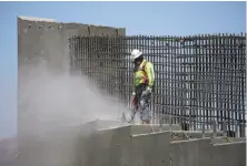  ?? John Locher / Associated Press ?? A man works on Interstate 11 near Boulder City, Nev. President Trump will outline his infrastruc­ture package this week.