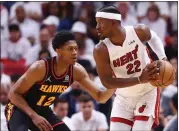  ?? MICHAEL REAVES — GETTY IMAGES ?? The Heat's Jimmy Butler, right, holds off the Hawks' De'Andre Hunter in Game 2of their series in Miami.